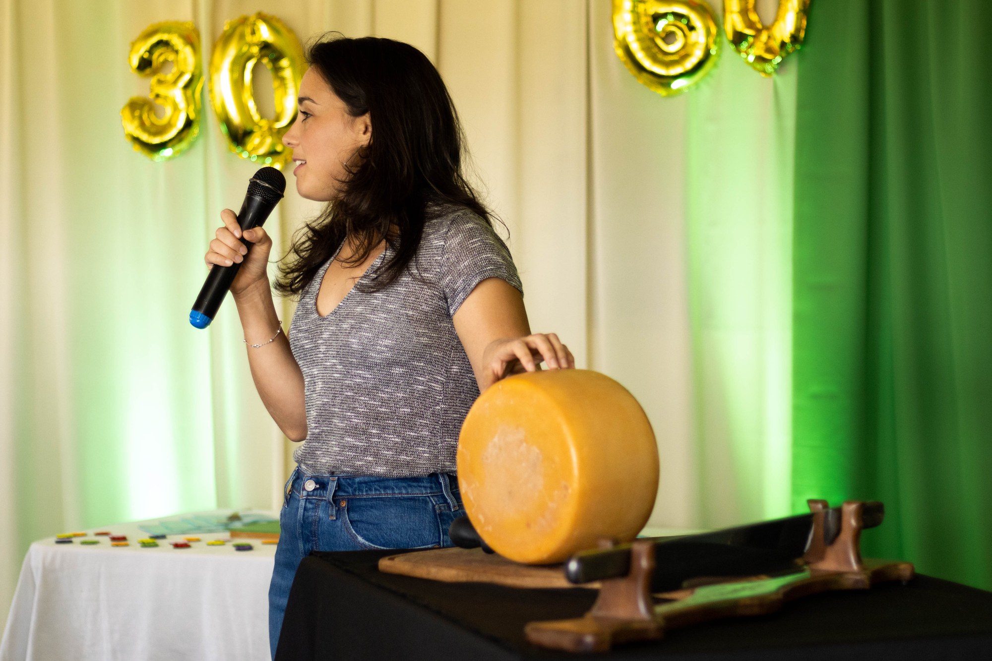 Vanesa with an artisanal cheese and microphone